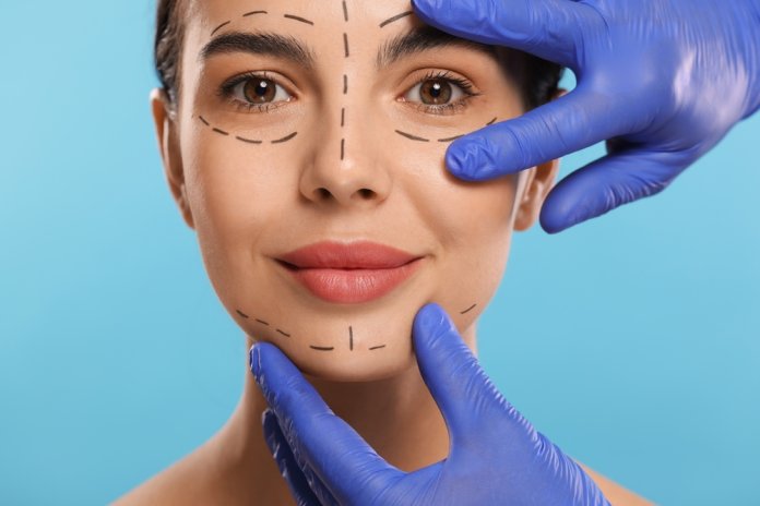Doctor,Checking,Marks,On,Woman's,Face,For,Cosmetic,Surgery,Operation